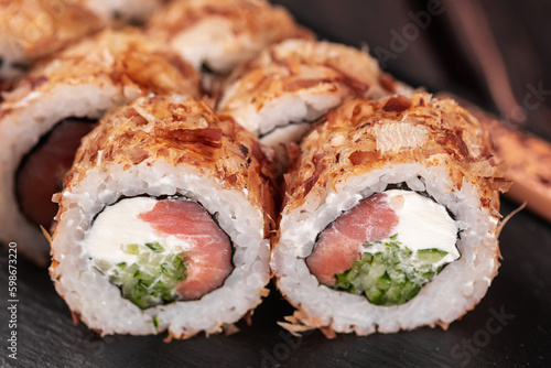 Salmon sushi roll with tuna flakes close-up - sushi asian menu and Japanese food