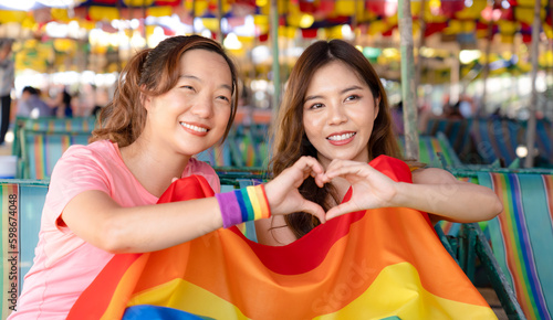 beautiful traveler lesbian couple have wonderful time together happy smiling for sexual freedom and racial diversity, LGBTQ+ people enjoy weekend outdoor activities during summer day in pride month © PINA