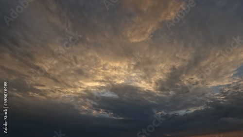 pretty dark evening sunset skyscape with beautiful clouds - photo of nature