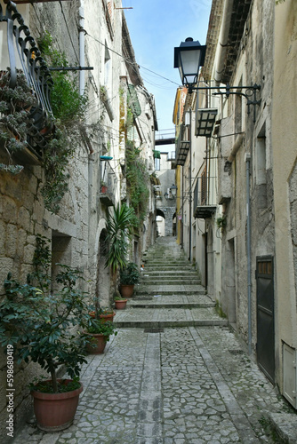 Fototapeta Naklejka Na Ścianę i Meble -  A narrow street among the old houses of Guardia Sanframondi, a small town of Benevento province, Italy.
