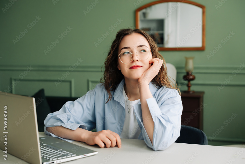 Serious Businesswoman Pondering Question or Idea on Laptop, Feeling Doubt While Working or Learning at Home or Office Serious Businesswoman Pondering Question or Idea on Laptop, Feeling Doubt While Working or Learning at Home or Office