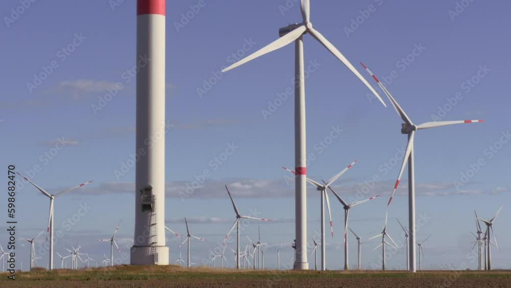 Many Wind Generators, Far and Close, Wind farm on an agricultural field , DAY Many Wind Generators, Far and Close, Wind farm on an agricultural field , DAY
