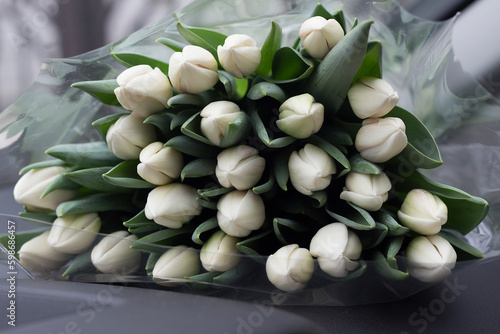 A huge bouquet of painful tulips in the car. Horizontal picture close up