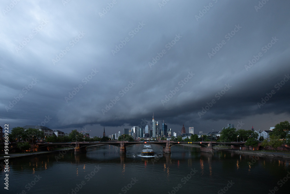 View of the financial district with the Main River and a bridge. Skyline in Frankfurt City, with thunderstorm Germany
