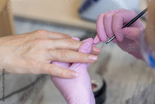 Nails manicure detail with file or brush item. Woman beautiful nail care process.