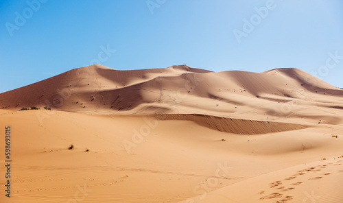 Landscape of sand dune with blue sky- travel in Morocco  tour tourism in Sahara desert