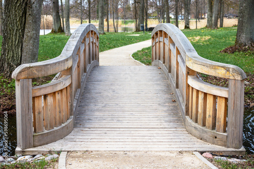 A wooden bridge with a bridge over a park.