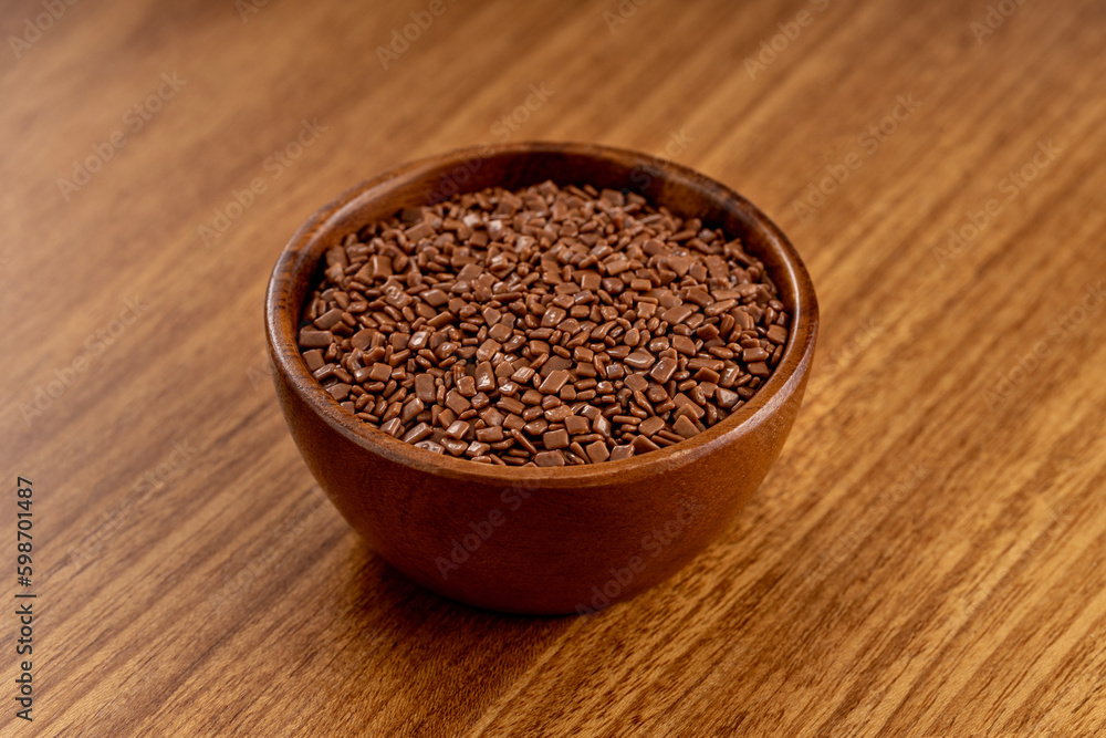 Chocolate gourmet sprinkles. 45 degree studio shoot isolated on wooden background. Chocolate gourmet sprinkles. 45 degree studio shoot isolated on wooden background.