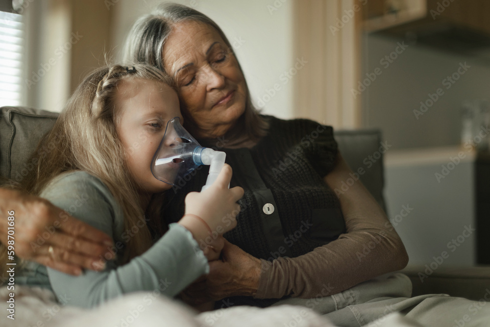 Senior woman taking care of her sick granddaughter. Senior woman taking care of her sick granddaughter.