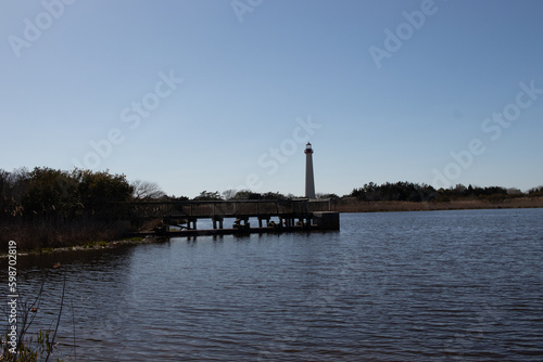 I love the look of this beautiful lighthouse off in the distance. This is Cape May point lighthouse in New Jersey. The beautiful dock in front with smooth pond looks so pretty.