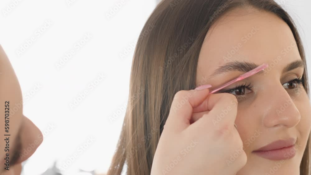A detailed frame that demonstrates the process of straightening and laying out eyebrow hairs to create a luxurious look. Young woman at a cosmetologist in a beauty clinic Generative AI A detailed frame that demonstrates the process of straightening and laying out eyebrow hairs to create a luxurious look. Young woman at a cosmetologist in a beauty clinic Generative AI
