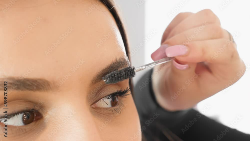 Close-up of brushing eyebrows. The eyebrow master adjusts the shape. The beautician works in a beauty salon. Young attractive woman at an appointment in a beauty clinic. Generative AI Close-up of brushing eyebrows. The eyebrow master adjusts the shape. The beautician works in a beauty salon. Young attractive woman at an appointment in a beauty clinic. Generative AI