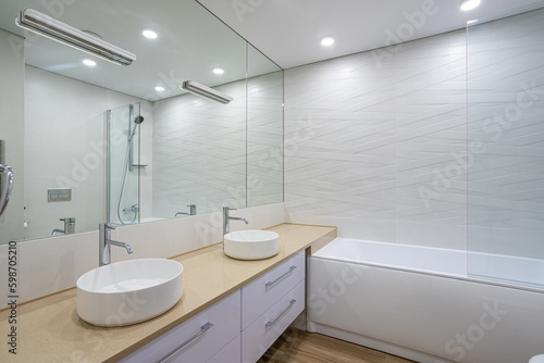white bathtub  sink and mirror