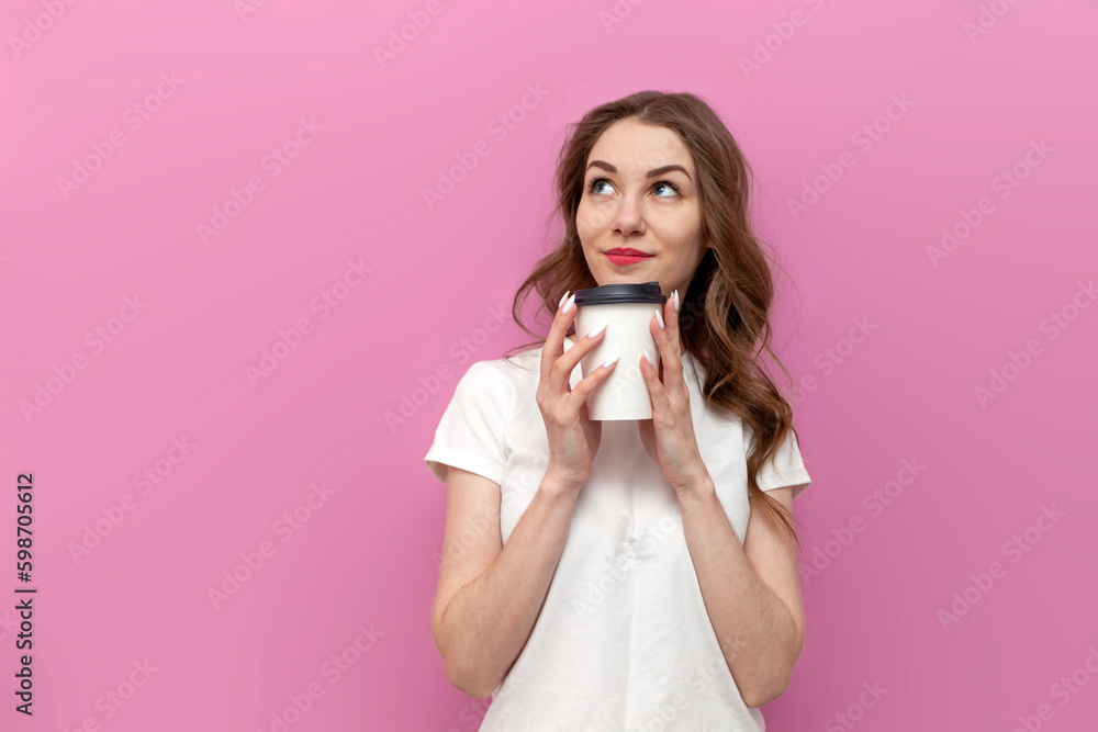 young pensive woman holding paper cup with coffee and looking at copy space, girl in white t-shirt with drink thinks young pensive woman holding paper cup with coffee and looking at copy space, girl in white t-shirt with drink thinks