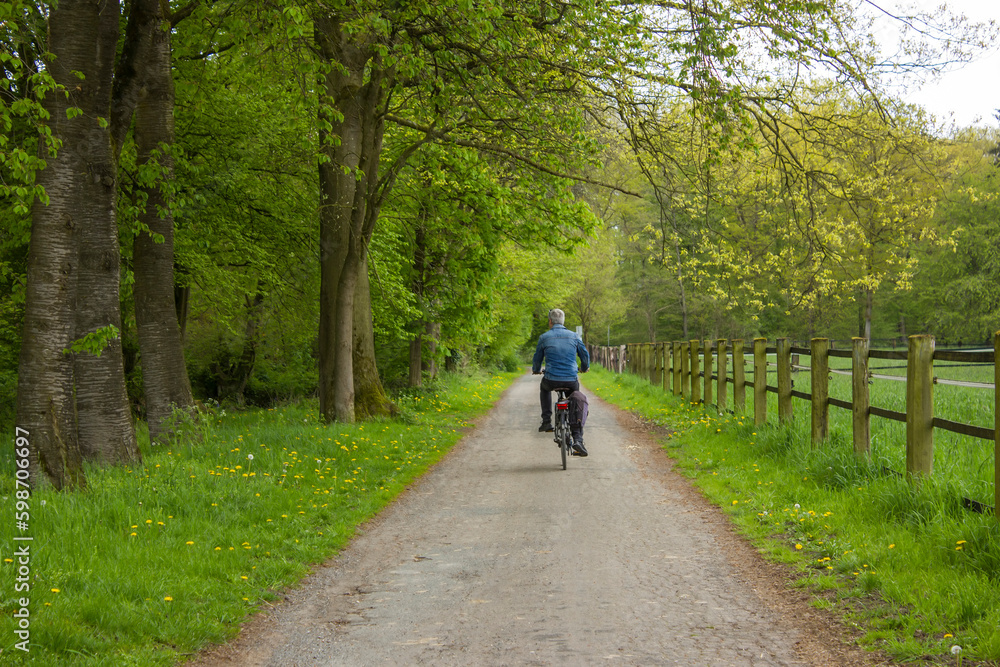 Cyclists racing on country roads on a sunny day, Germany Cyclists racing on country roads on a sunny day, Germany