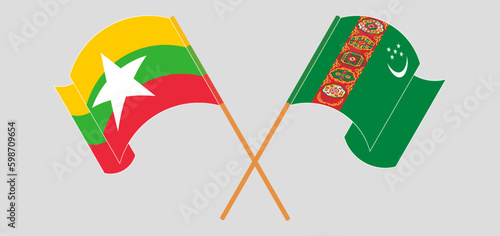 Crossed and waving flags of Myanmar and Turkmenistan.