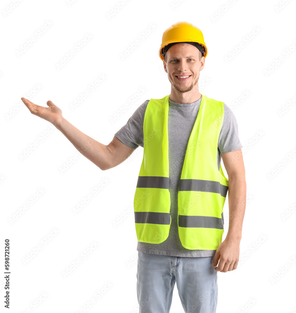 Male worker in vest and hardhat showing something on white background Male worker in vest and hardhat showing something on white background