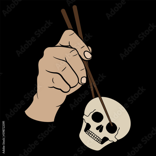 Human hand holding skull with chopsticks. Devour death. Creative concept. On black background.