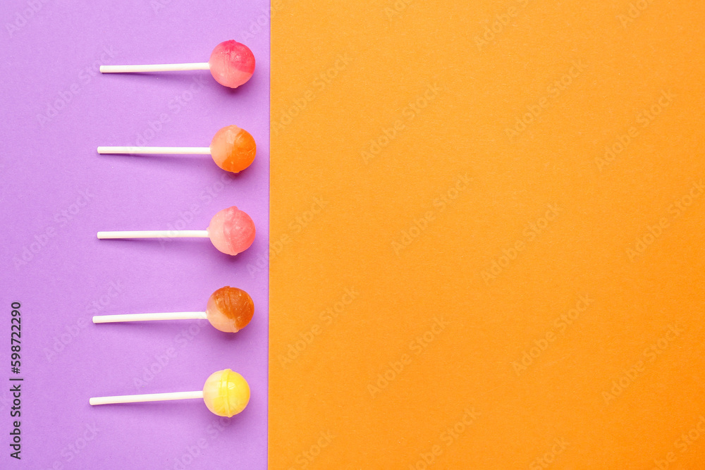 Sweet lollipops on purple and orange background Sweet lollipops on purple and orange background