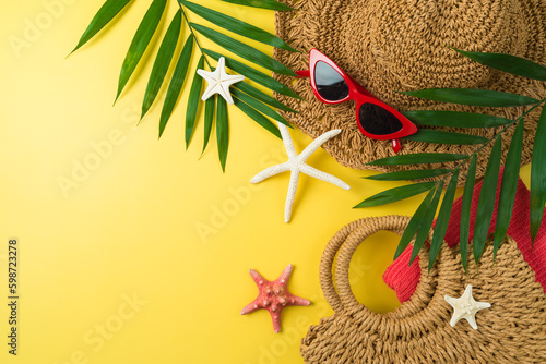 Summer holiday vacation background with straw hat, bag and beach accessories. Top view from above