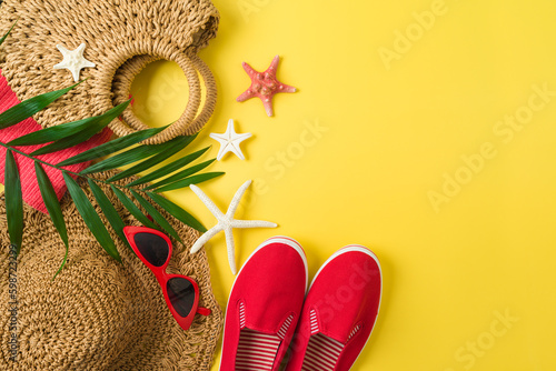 Summer holiday vacation background with straw hat, bag and beach accessories. Top view from above