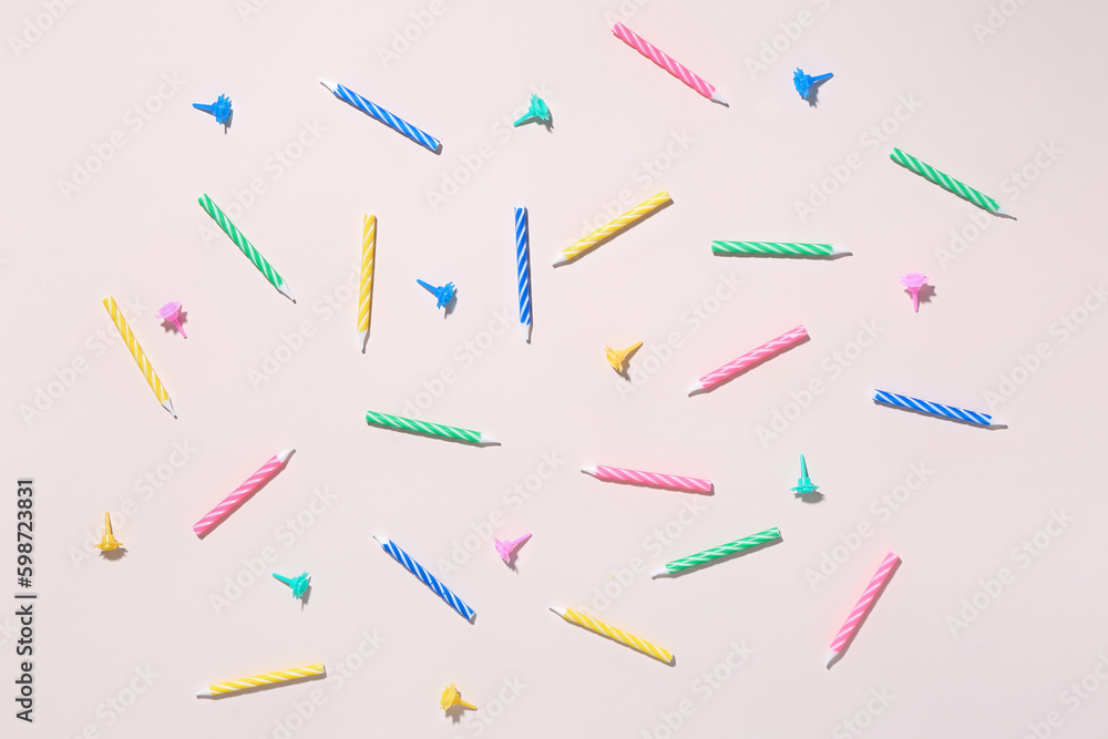 Colorful birthday candles on pink background Colorful birthday candles on pink background
