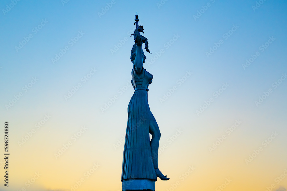 Fototapeta premium Beautiful sunrise view from wooden pier on Imperia statue at harbor entrance and Lake Constance in early morning hours. Steamer harbor, Constance, Baden-Württemberg, Germany, Europe.
