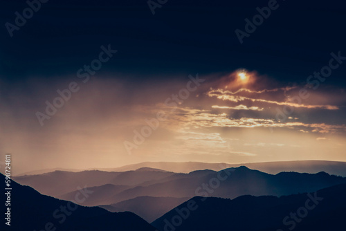 banner of mountain peaks in beautiful stormy sunset light