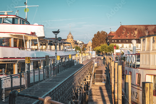 Beautiful sunrise view from Imperia statue at harbor entrance on concil building in early morning hours. Steamer harbor, Constance, Baden-Württemberg, Germany, Europe. photo