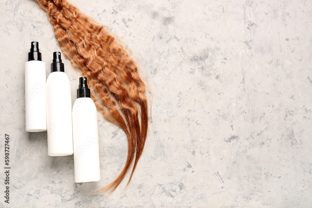Curly ginger hair with sprays on grunge background Curly ginger hair with sprays on grunge background