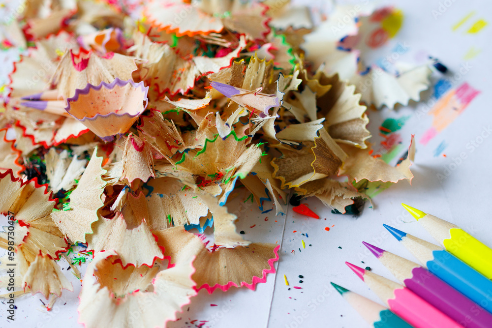 Closeup pencil and color pencil stack with shavings. Artistic education concept white background. Closeup pencil and color pencil stack with shavings. Artistic education concept white background.