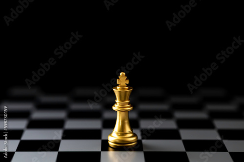 Golden King chess standing on chess board.
