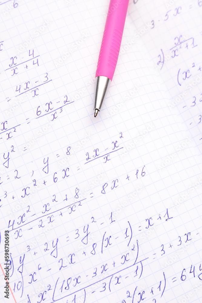 Copybook with maths formulas and pen, closeup Copybook with maths formulas and pen, closeup