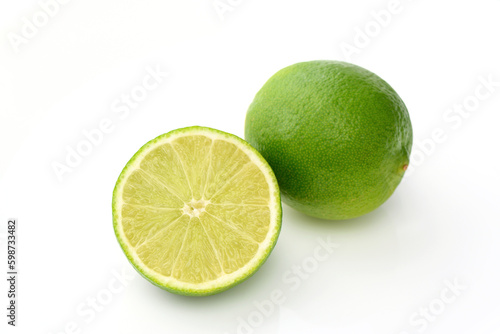 whole lime and sliced ​​lime on white background with shadows 1