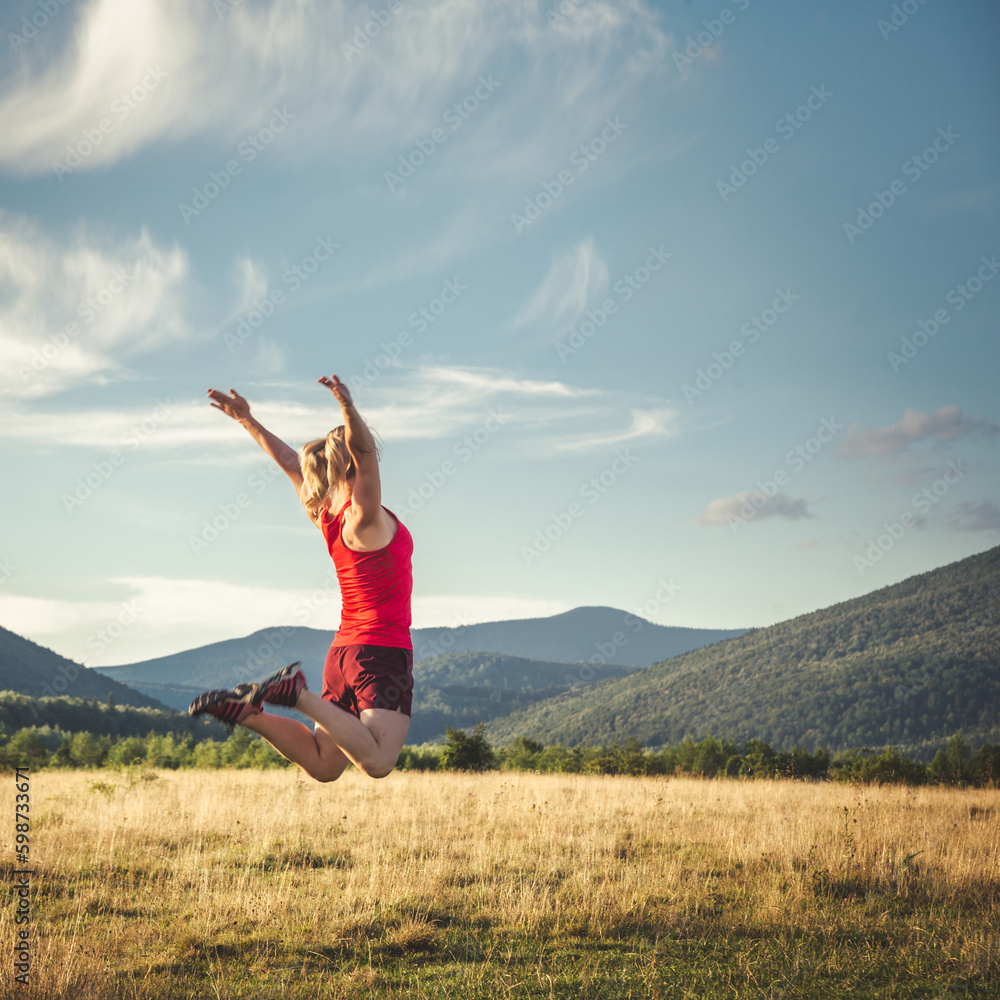 Young woman on the top of mountain Young woman on the top of mountain