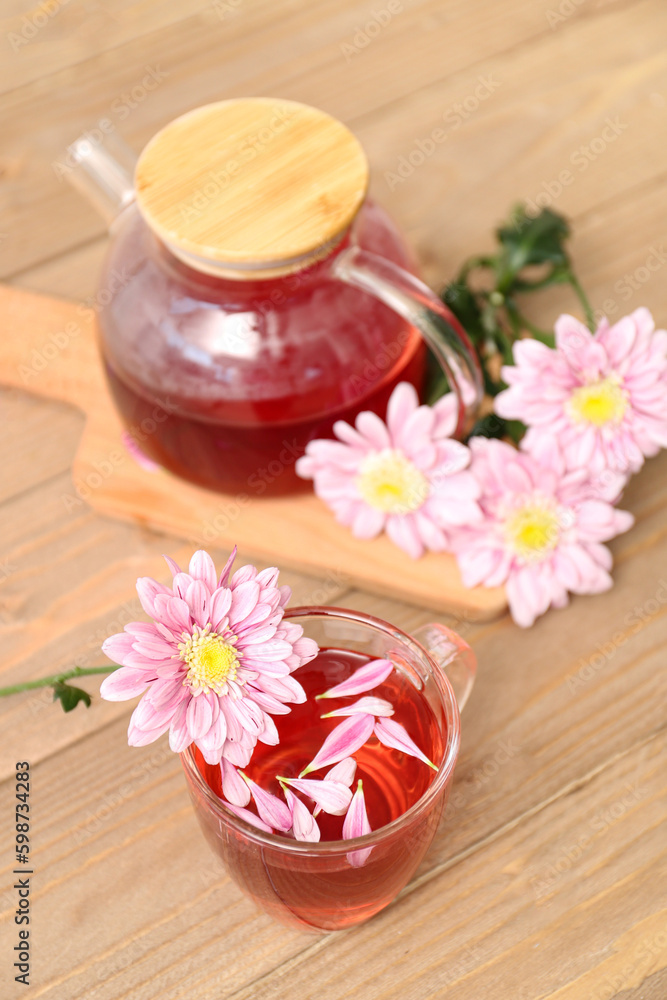 Beautiful tea set with chrysanthemums on wooden table Beautiful tea set with chrysanthemums on wooden table