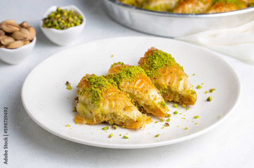 Turkish Dessert Sobiyet Baklava. Turkish pistachio baklava on a white background. Local name şöbiyet baklava