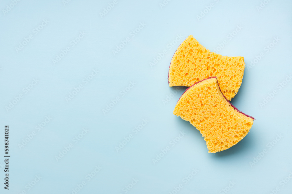 Sponges for washing dishes on blue background. Top view. Sponges for washing dishes on blue background. Top view.