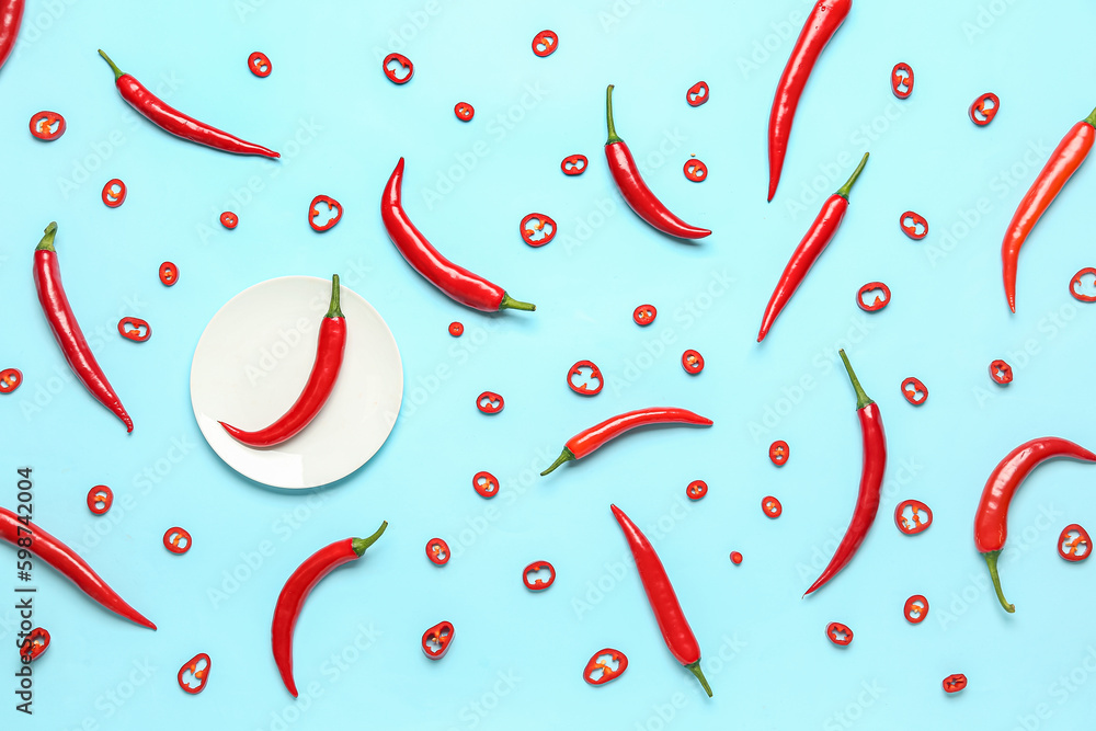 Plate with fresh chili peppers on blue background Plate with fresh chili peppers on blue background