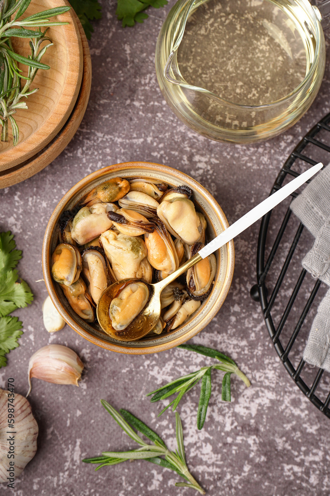 Bowl with pickled mussels on grey grunge table
