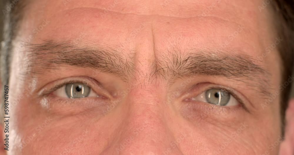 Playful look of a man close-up. He looks at a point with his eyes, moves his head from side to side. Soft focus, head movement. Generative AI Playful look of a man close-up. He looks at a point with his eyes, moves his head from side to side. Soft focus, head movement. Generative AI