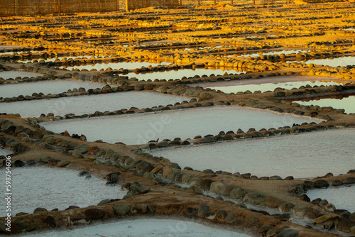 Salt farm in the morning, close-up view of salt ponds