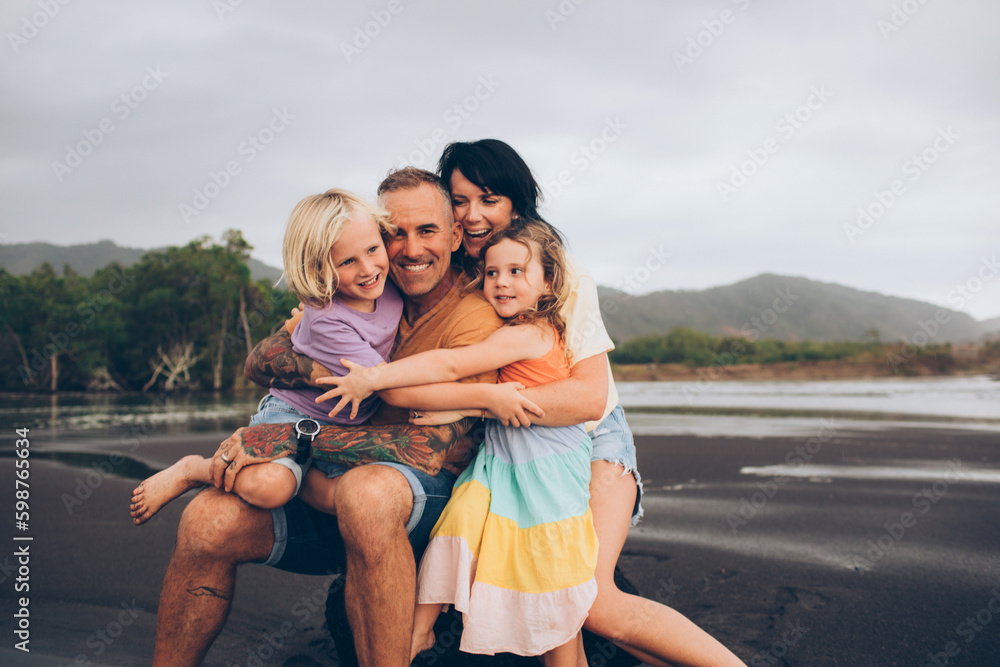 family hugging at the beach close up