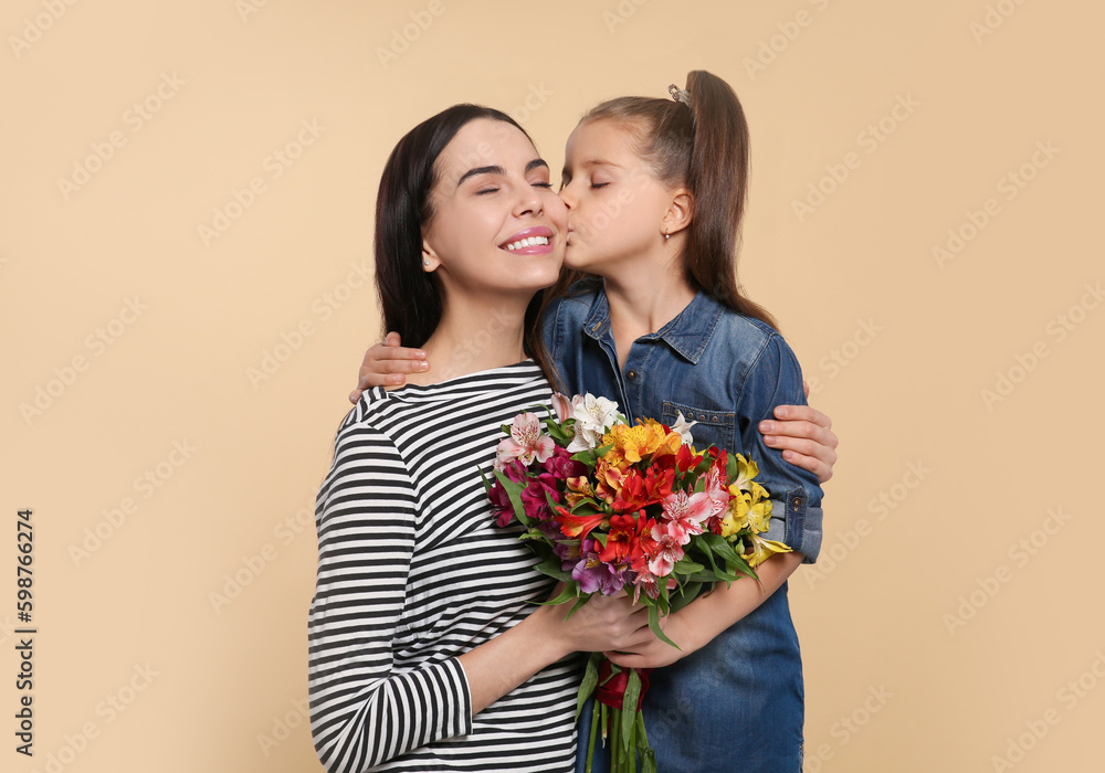 Happy woman with her cute daughter and bouquet of beautiful flowers on beige background, space for text. Mother's day celebration Happy woman with her cute daughter and bouquet of beautiful flowers on beige background, space for text. Mother's day celebration