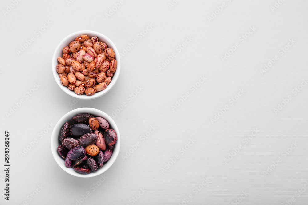 Different kinds of kidney beans on white background, top view. Space for text Different kinds of kidney beans on white background, top view. Space for text
