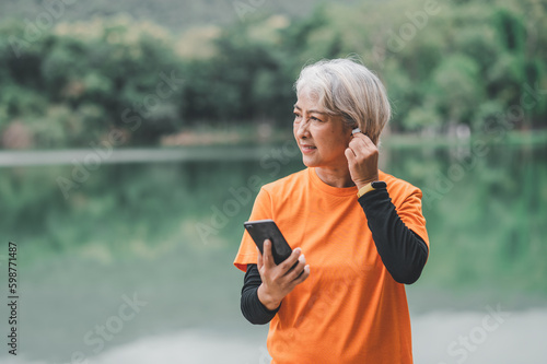 white-haired elderly person exercising in the park early in the morning.