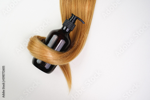 Hair health shampoo. Blond hair on a white background. Place for text. advertising banner. Hair care product. keratin hair restoration