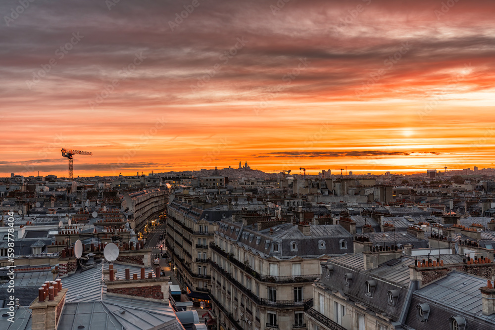 Sunrise above Paris skyline, warm colorful sky, France. View from the roof