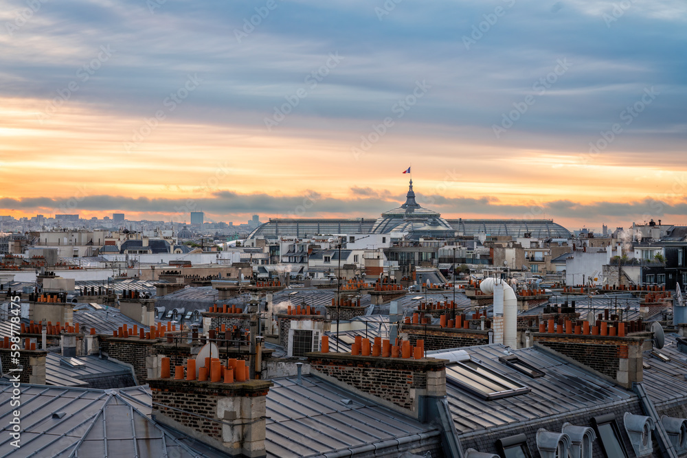 Sunrise above Paris skyline, France. View from the roof of old town building