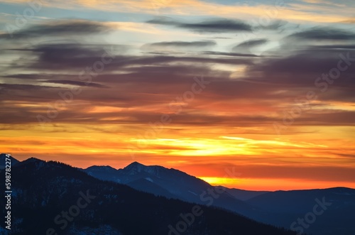 Beautiful mountain theme to use for example as a background. Colorful sunset over the peaks in the Polish Tatra Mountains. © shadowmoon30